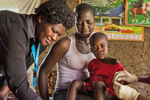 Nurse visits child with malaria in Kenya