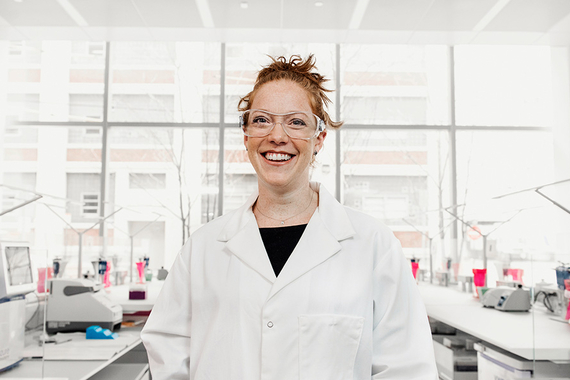 Smiling scientist in a lab wearing security glasses