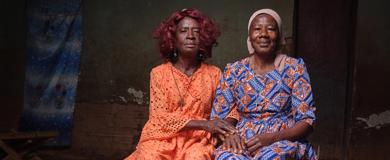 Sitting portrait of two women in colorful traditional dresses in Cameroon
