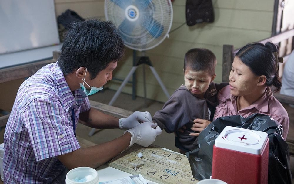 Clinician draws blood from a child.