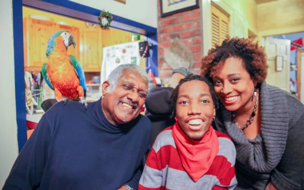 Sickle cell disease patient and doctor, Tartania, poses with her brother and father in New York