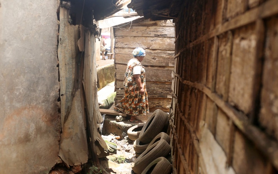 Nyintché walks through the neighborhood in Briqueterie, Yaoundé.