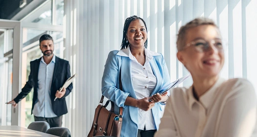 Three business people in a modern and bright meeting room