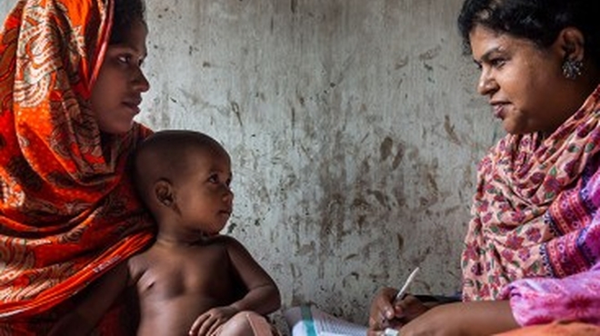 A mother and child in Bangladesh are interviewed by a nurse A mother and child in Bangladesh are interviewed by a nurse