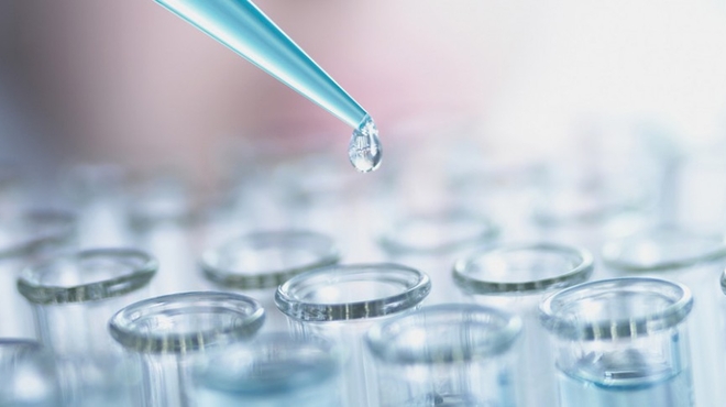 Laboratory scientist performing tests for cancer research A scientist performs tests for cancer research with pipette and test tubes