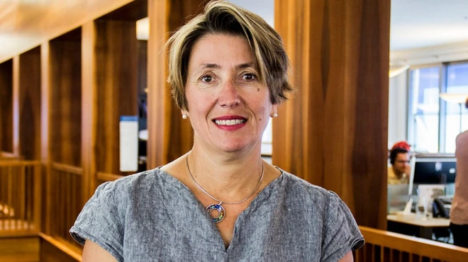 Ana Graf standing in the hallway of an office building in Basel