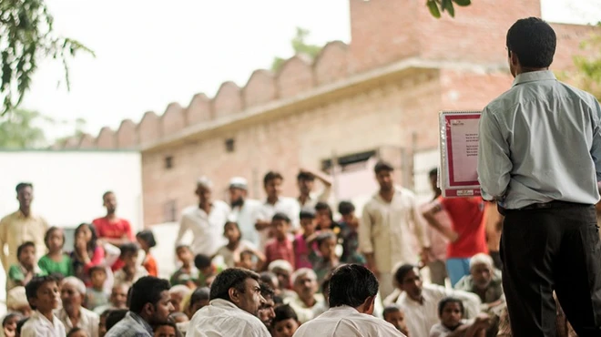 Health educator Chankey Kumar addresses people in the northern Indian village of Mulehra