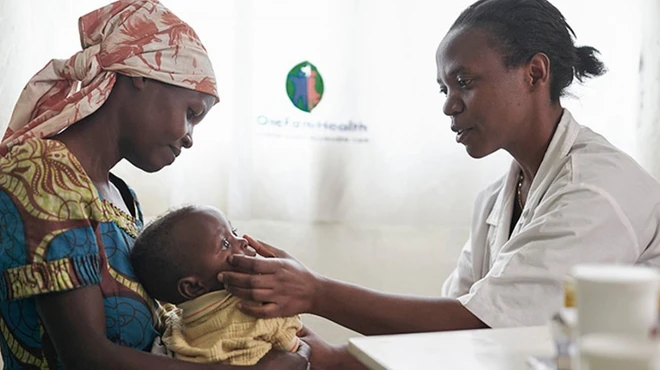 Doctor examining baby in Rwanda