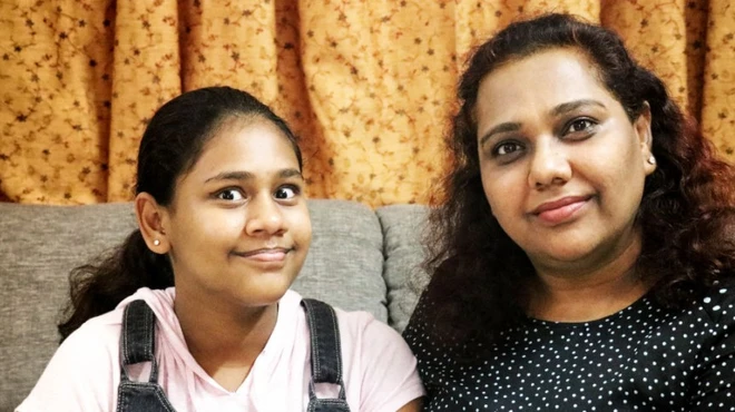 Deepti Mittal sitting with her daughter in Hyderabad, India