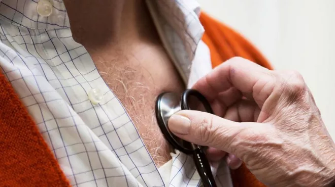 Heart failure patient receives care from his doctor