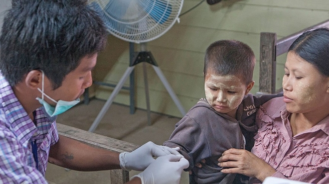 Young child next to his mother getting examine