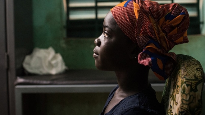 A young girl sits at a health clinic in Sikasso, Mali. A young girl sits at a health clinic in Sikasso, Mali.