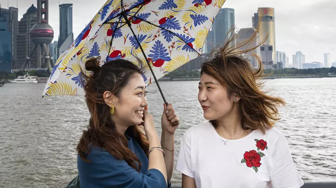 Portrait of two chinese women holding an umbrella