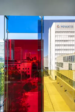 View of the Novartis logo through the colorful façade of Forum 3, Novartis Campus Basel (vertical)