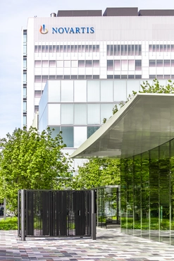 View of the Novartis logo on the Banting 1 building from the main gate, Novartis Campus Basel (vertical)
