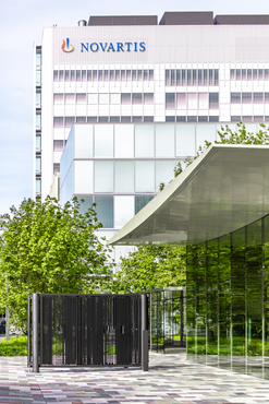 View of the Novartis logo on the Banting 1 building from the main gate, Novartis Campus Basel (vertical)