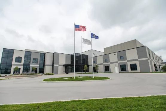 Three flags fly outside a Novartis manufacturing facility