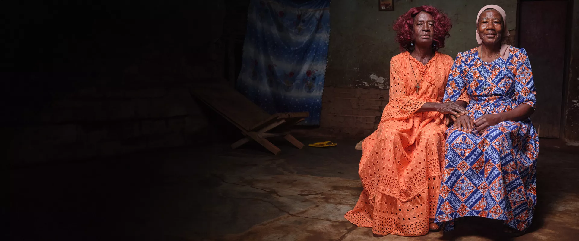 Sitting portrait of two women in colorful traditional dresses in Cameroon