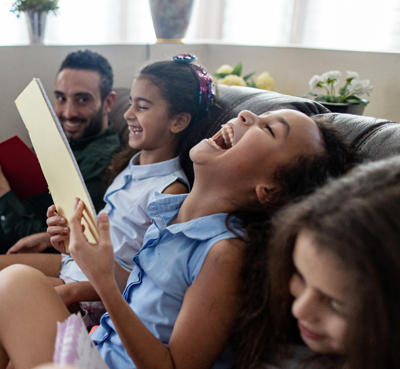 People laughing together on a sofa