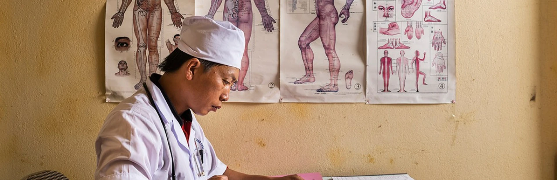 Dr. Chang As Xinh updates a patient's medical records at his surgery in Mù Cang Chải, Vietnam.