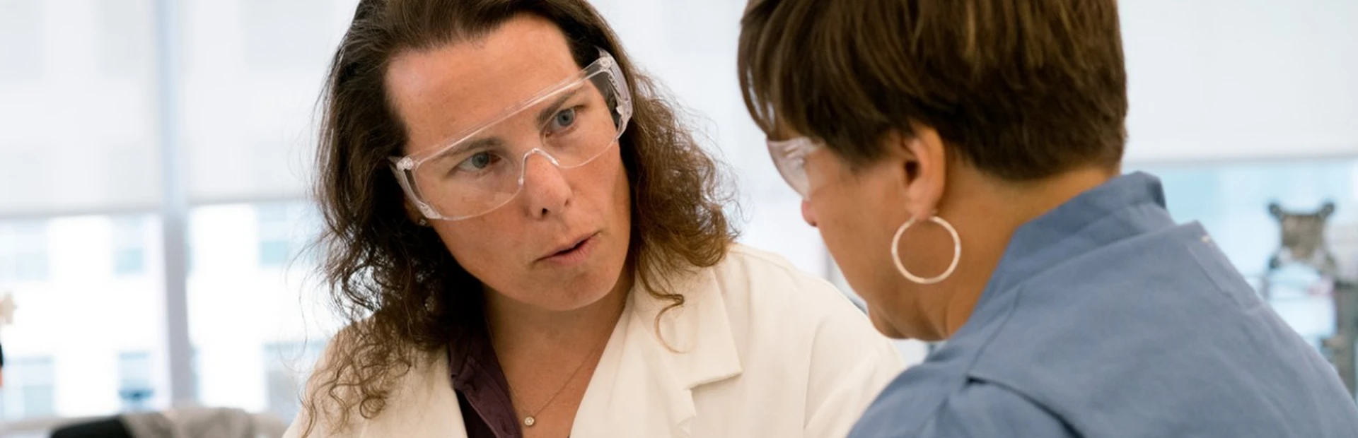 Jennifer Allport-Anderson shares scientific insights with a colleague