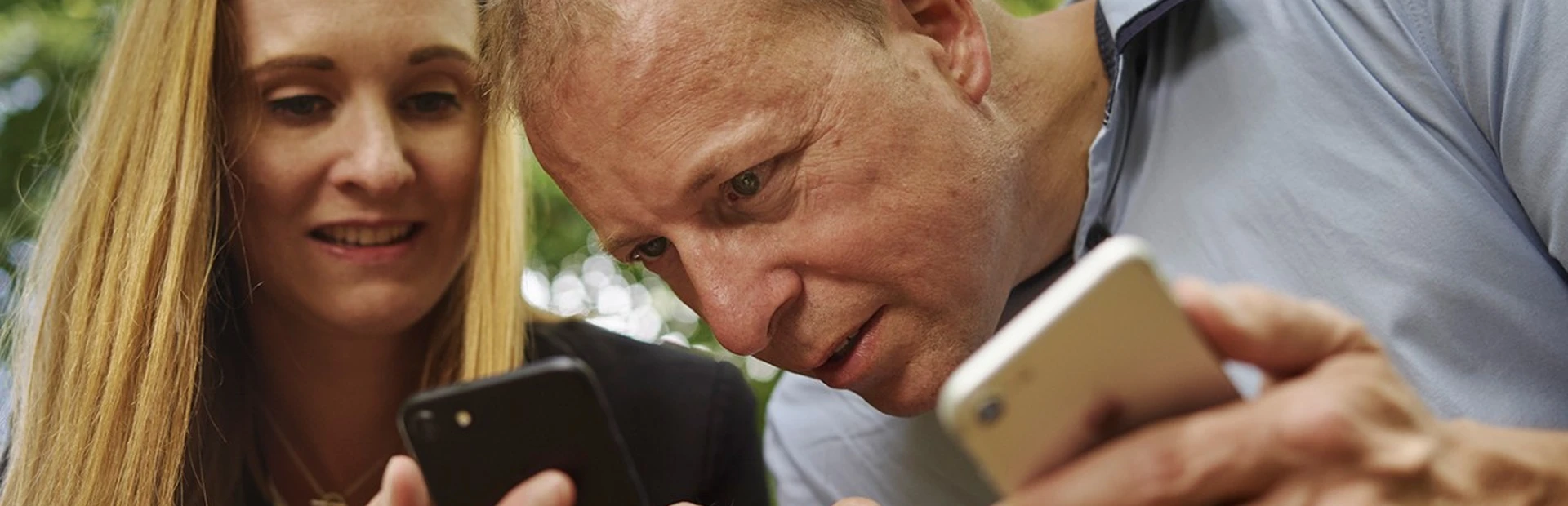 A couple showing each other data on their phones