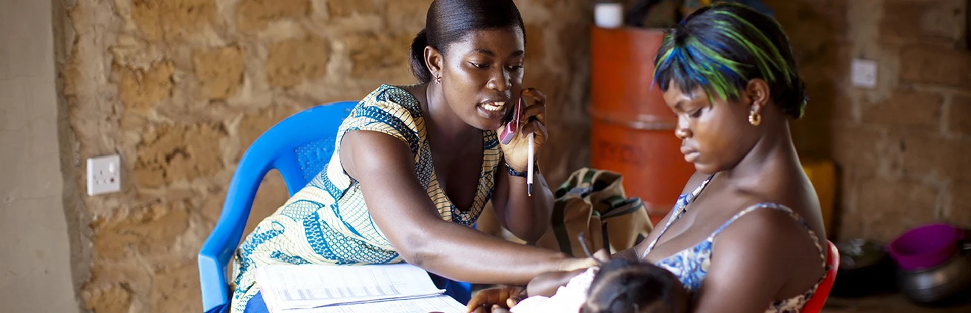 Medical worker talking on phone treating patients in Africa