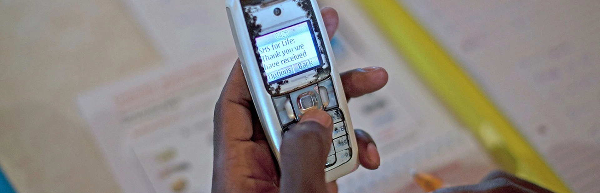 Mans hand sending SMS text message