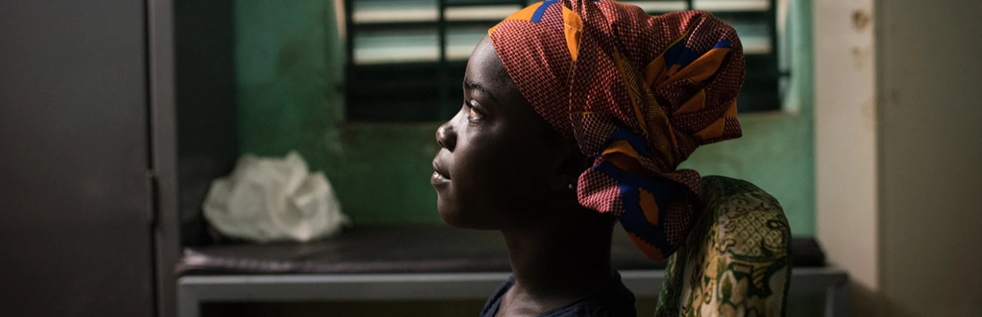 A young girl sits at a health clinic in Sikasso, Mali.