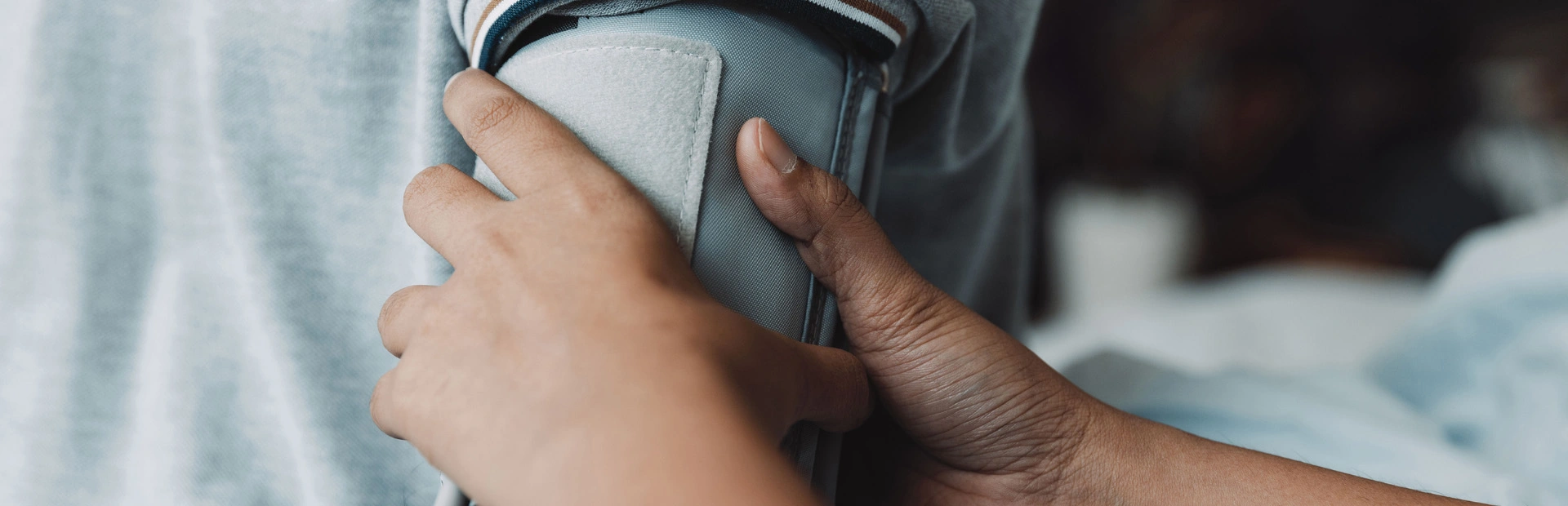 Healthcare professional uses blood pressure cuff on patient