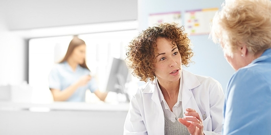A doctor speaks with a patient