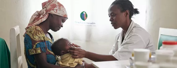 Doctor examining baby in Rwanda