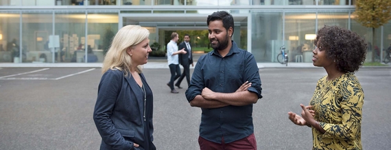 Three business people discussing on Novartis campus