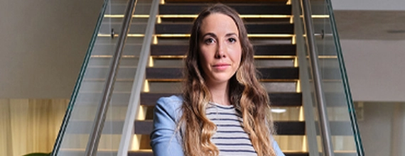 A female Director standing in-front of stairs at the Novartis office in Basel