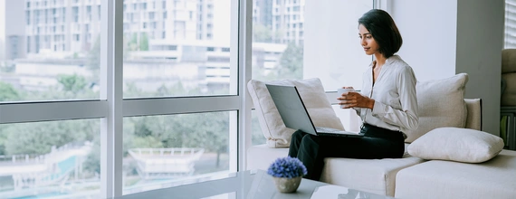 Business woman working on her laptop in a bright atmosphere