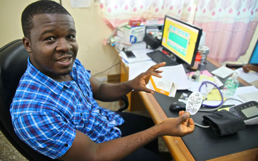 A doctor based at St. Martin’s Hospital holds a blood pressure monitor.