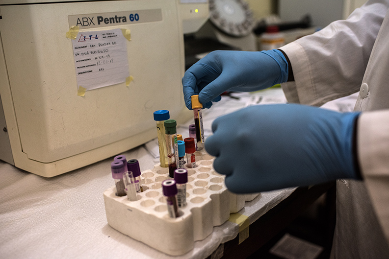 Test tubes being examined by a researcher