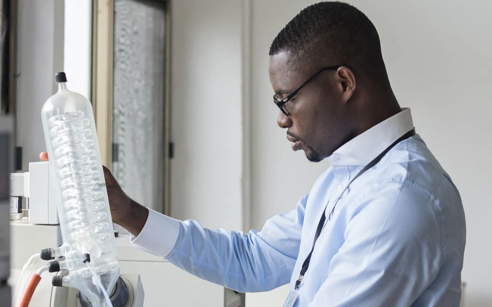Back in the laboratory, Mr. Ekuadzi checks the equipment used to analyze plant samples