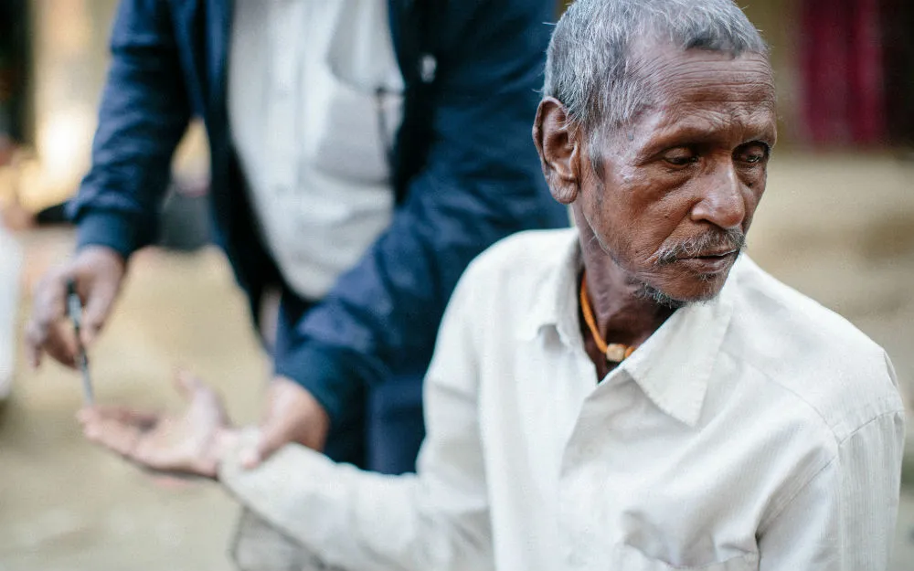 Man being tested for leprosy with pen
