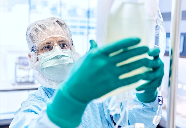 A Cell Processing Specialist at work in the production training environment