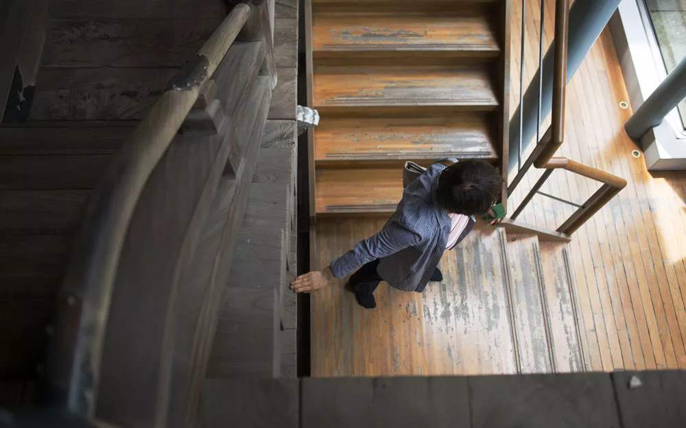 Ms. Yoshikawa navigating a staircase at a historic shrine.