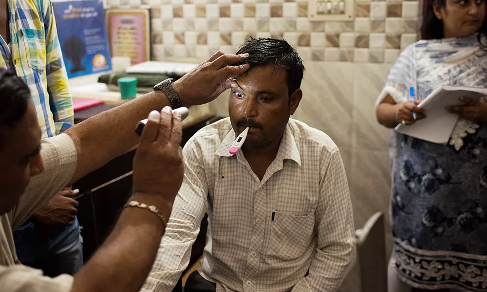 A patient receives a checkup at a health camp in the northern Indian village of Triveni Vihar.