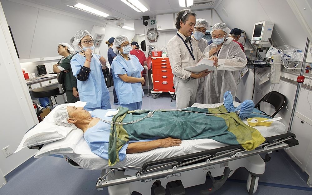 Dr. Lehmann discusses pre-surgery procedures as a part of hands-on training aboard the hospital