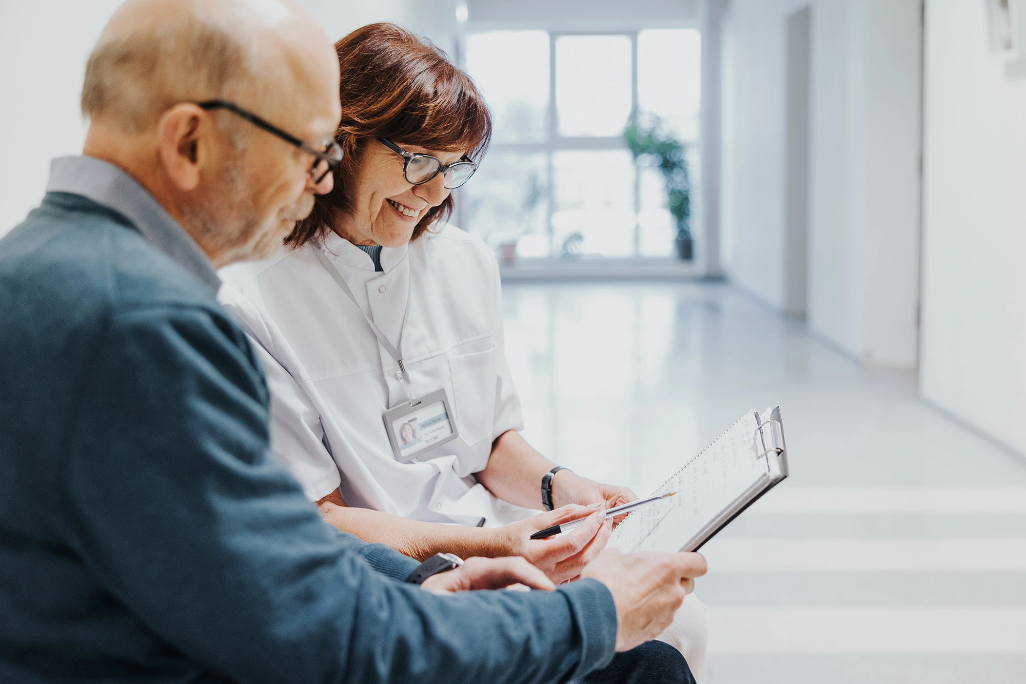 doctor taking patient information in a waiting room