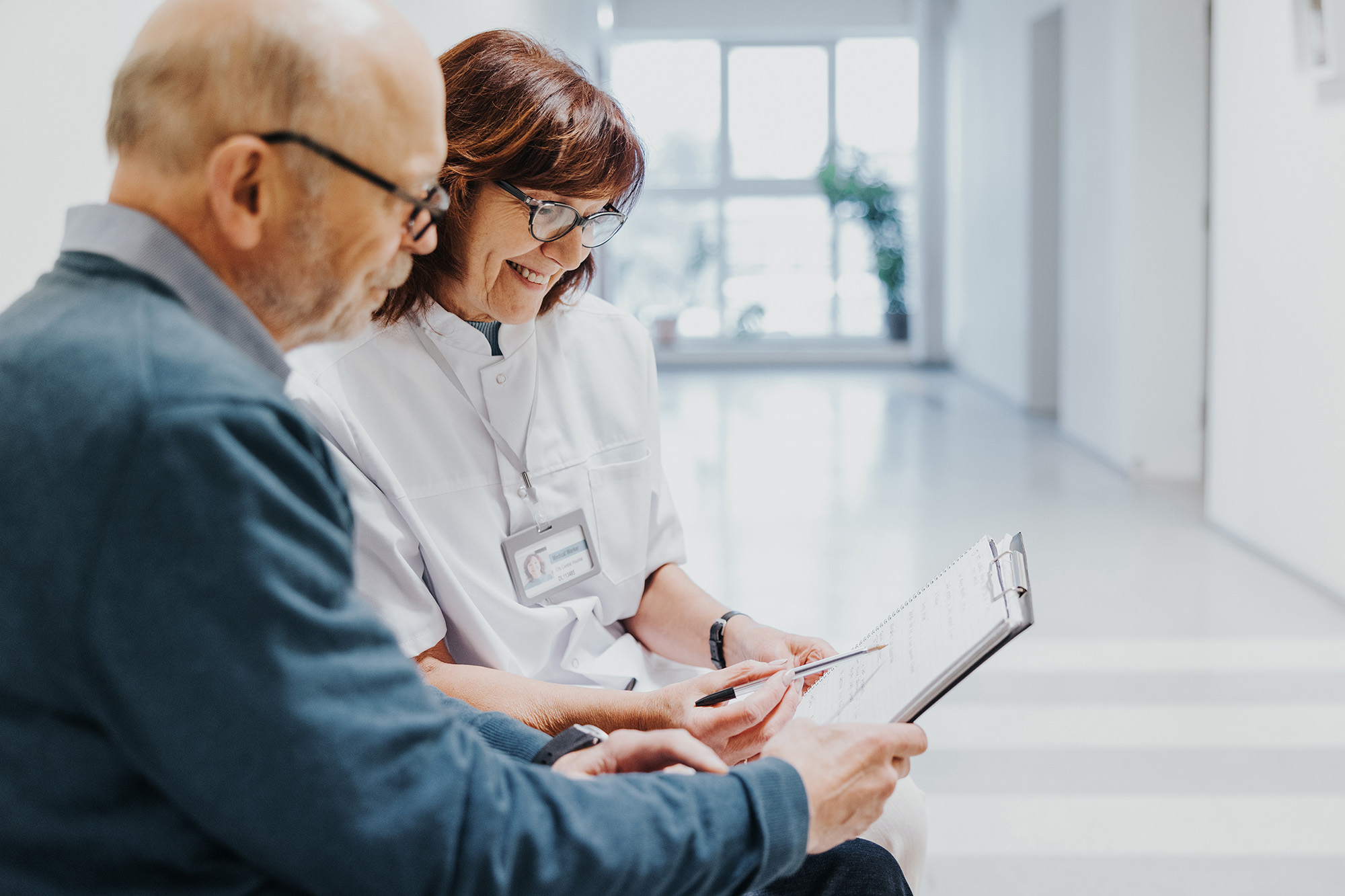 doctor taking patient information in a waiting room
