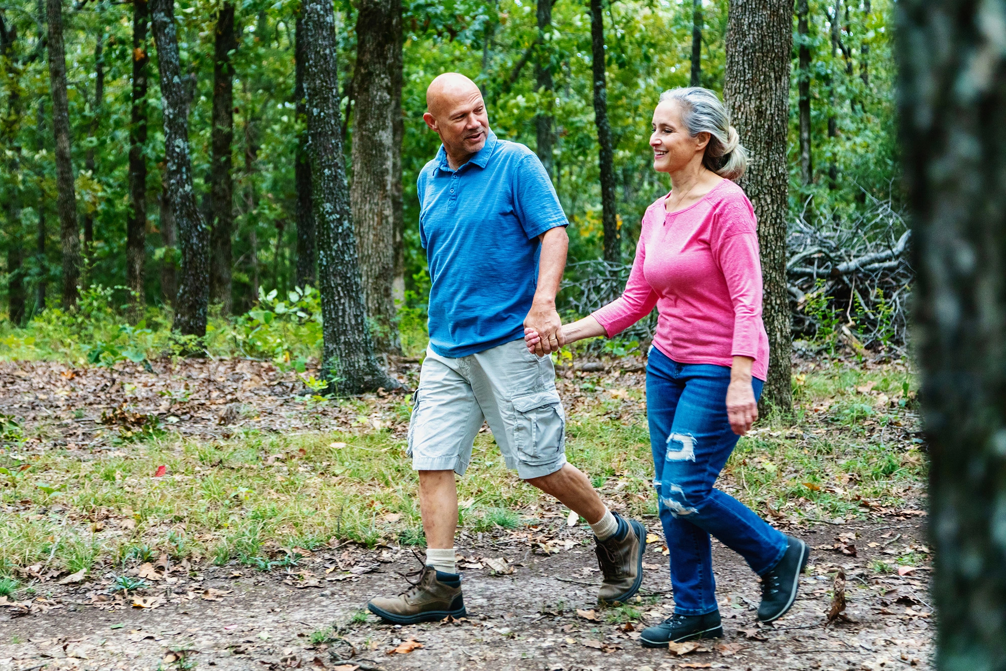 two adults hiking in a forrest