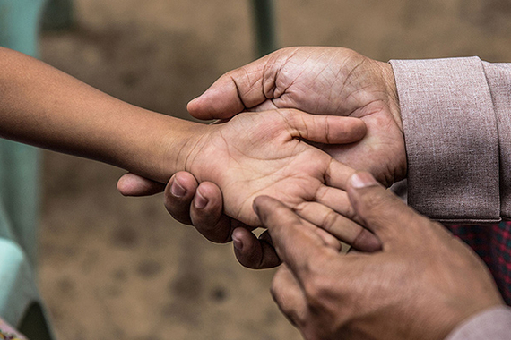 Screening child for leprosy in Asia