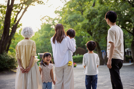 A family standing outside looking into the sunset