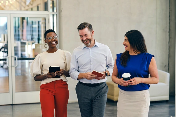 Three business people laughing