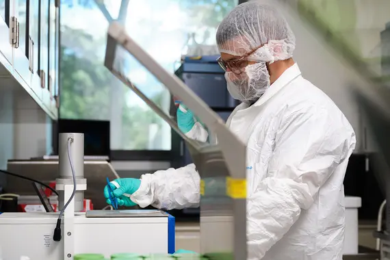 Scientist in protective gear working in a laboratory